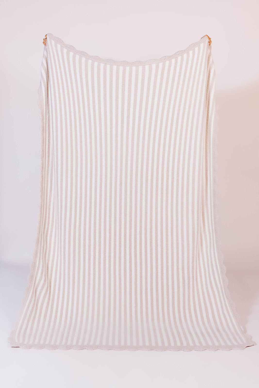 holding up the blanket to show the full details