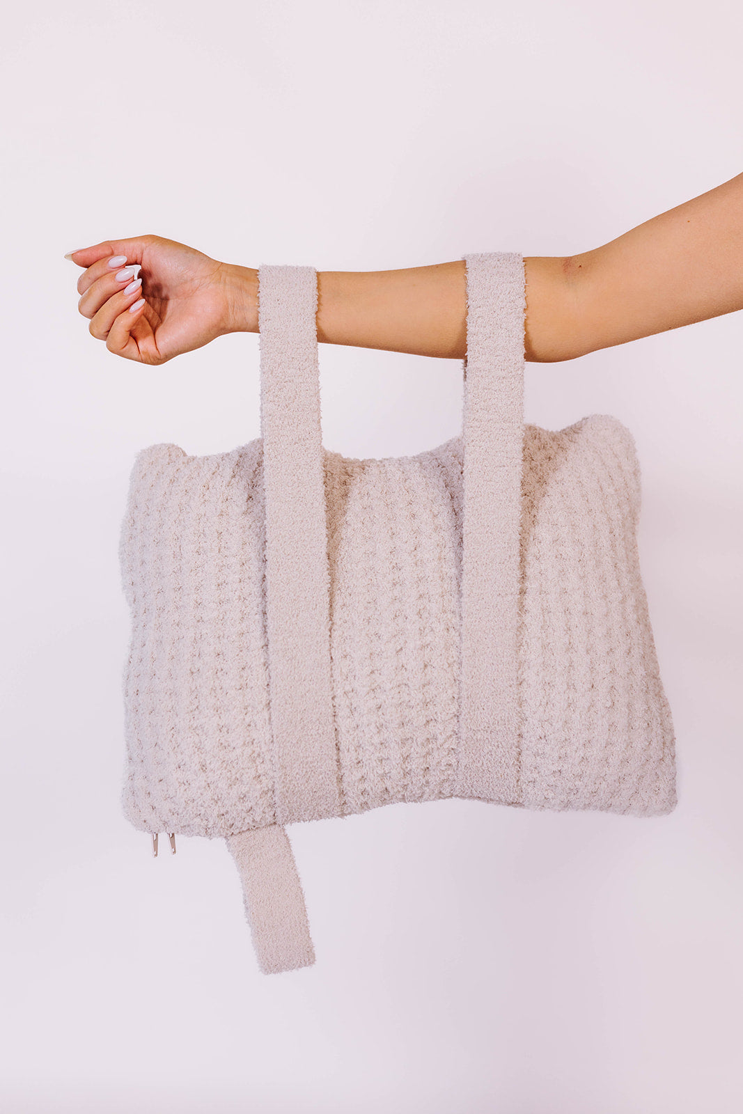 holding the quillow by the backpack straps