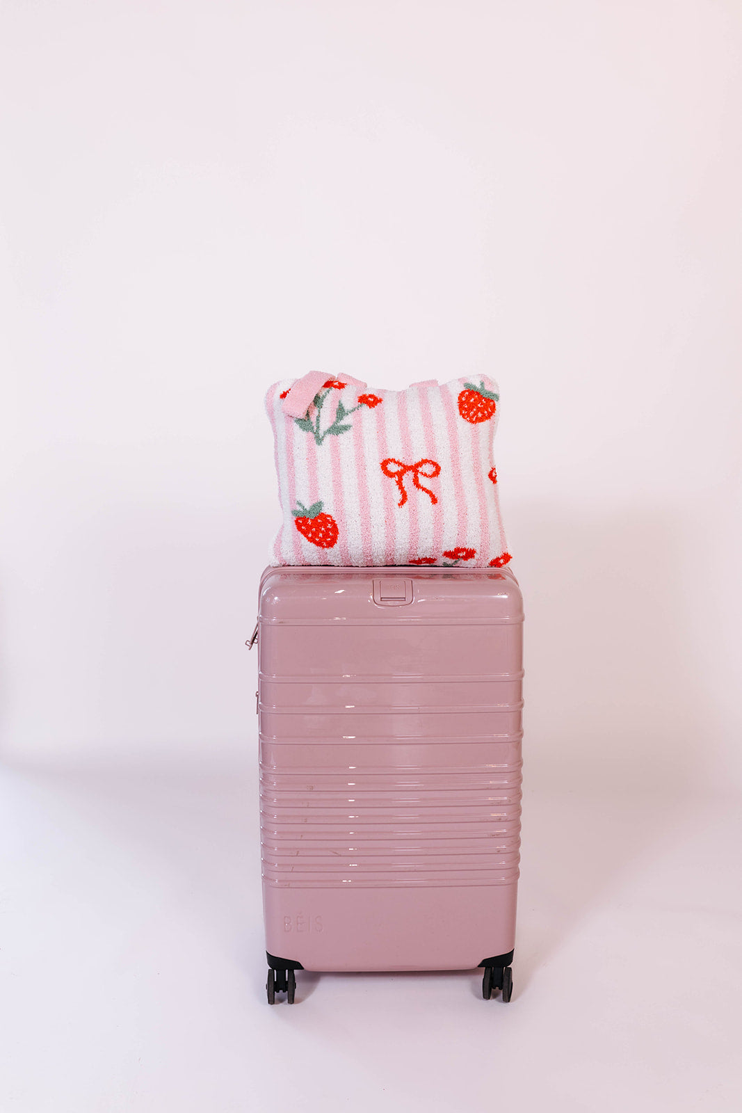 quillow on the pink beis suitcase