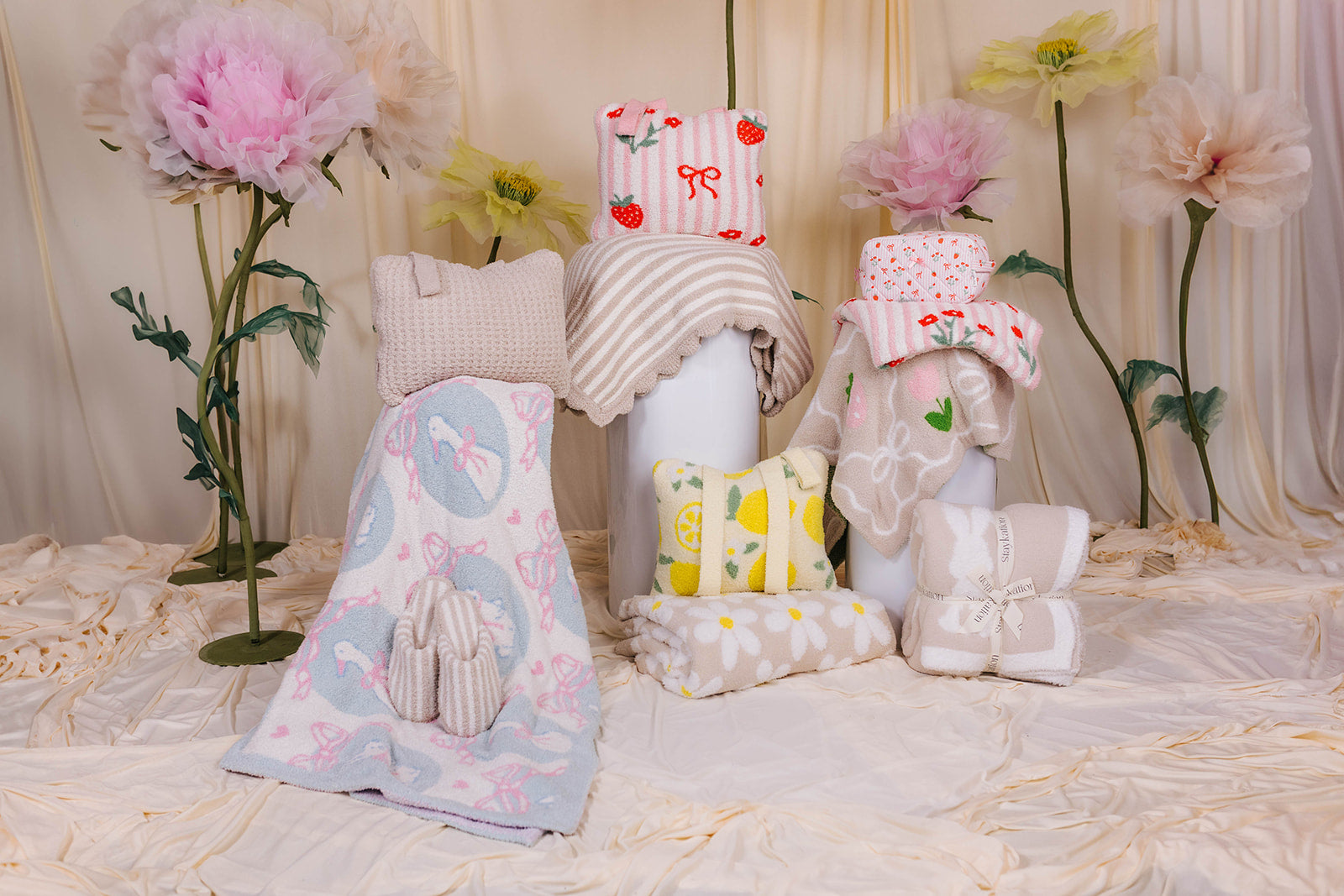 The full collection styled in front of the daisy props