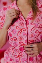 close up of the candy heart pjs showing the bows and candy heart icons