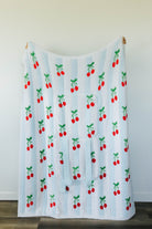 Blanket with cherry pattern on a white background