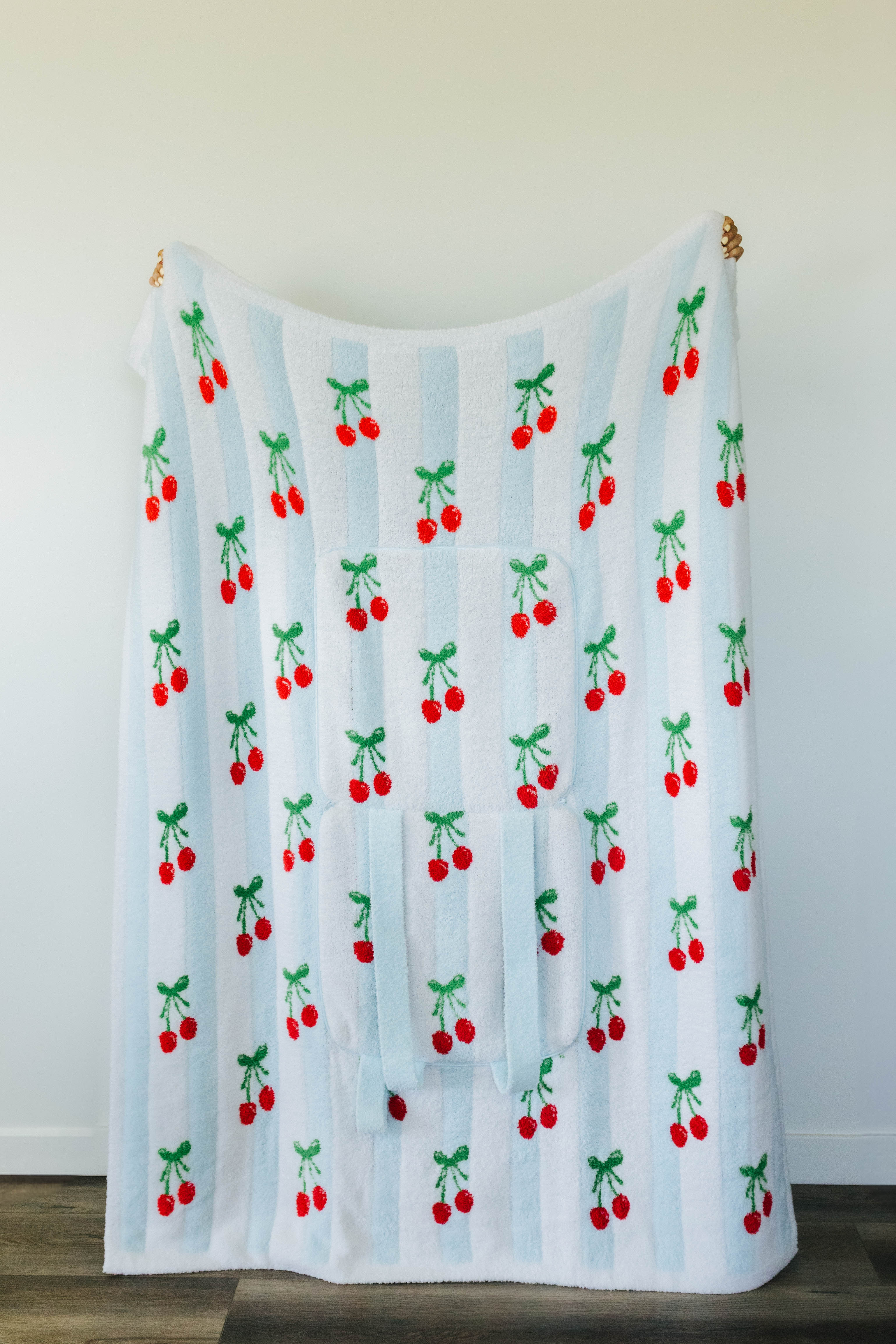 Blanket with cherry pattern on a white background