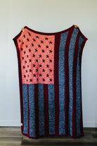 American flag quillow unfolded hanging against a white wall- back side