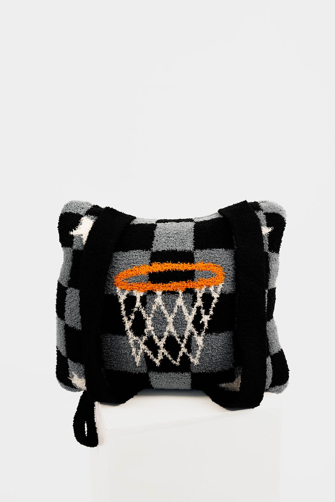 Checkered patterned quillow with a basketball hoop design on a white background