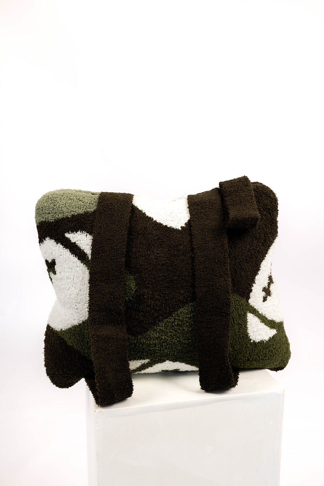 Decorative pillow with camo pattern and football designs on a white background