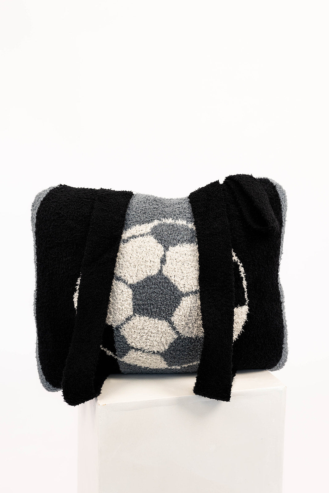Quillow with soccer ball pattern on a white background