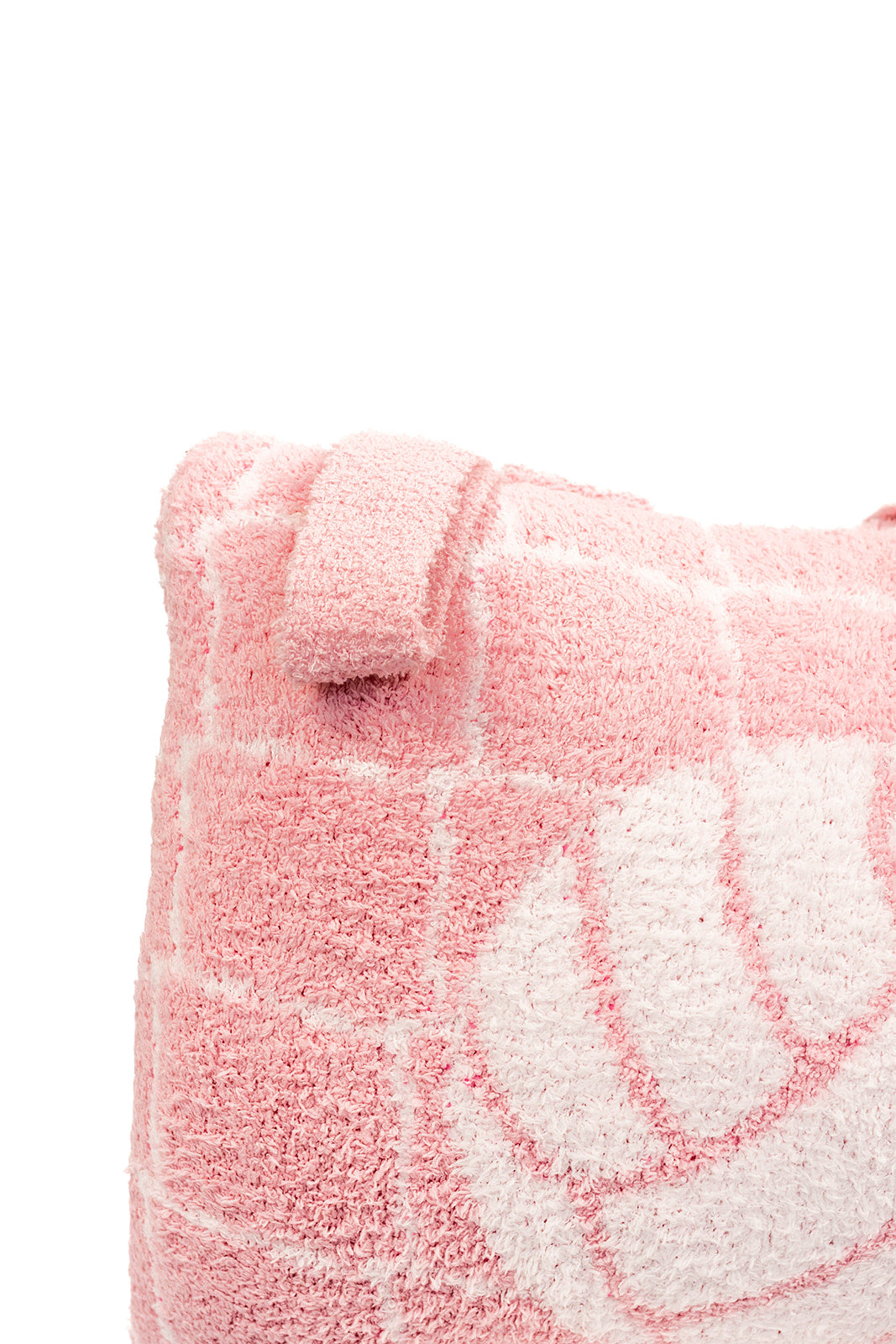 Close-up of a pink quillow with a white volleyball design on a white background