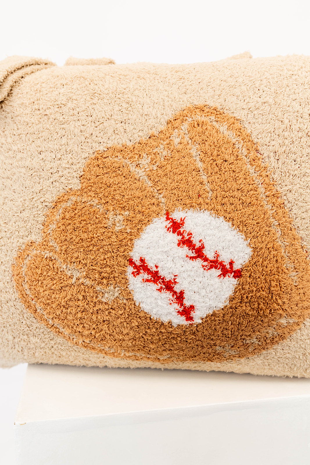 beige quillow with a baseball and glove design on a beige background