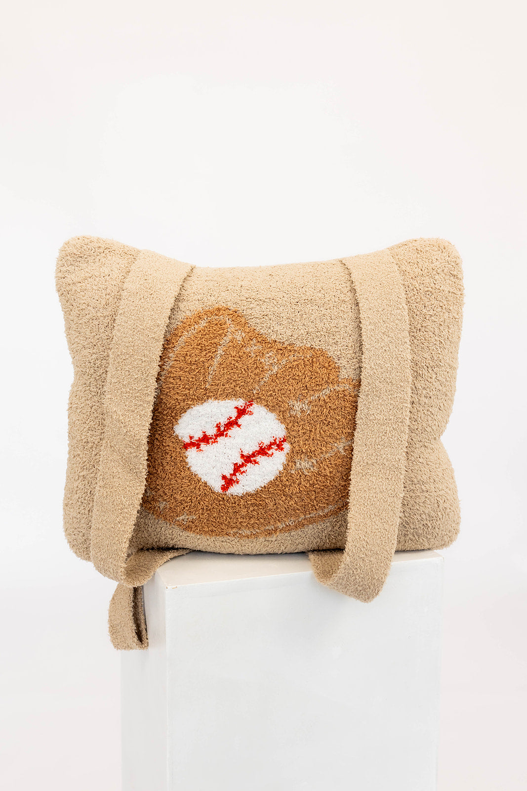 Beige quillow with a baseball design on a white background