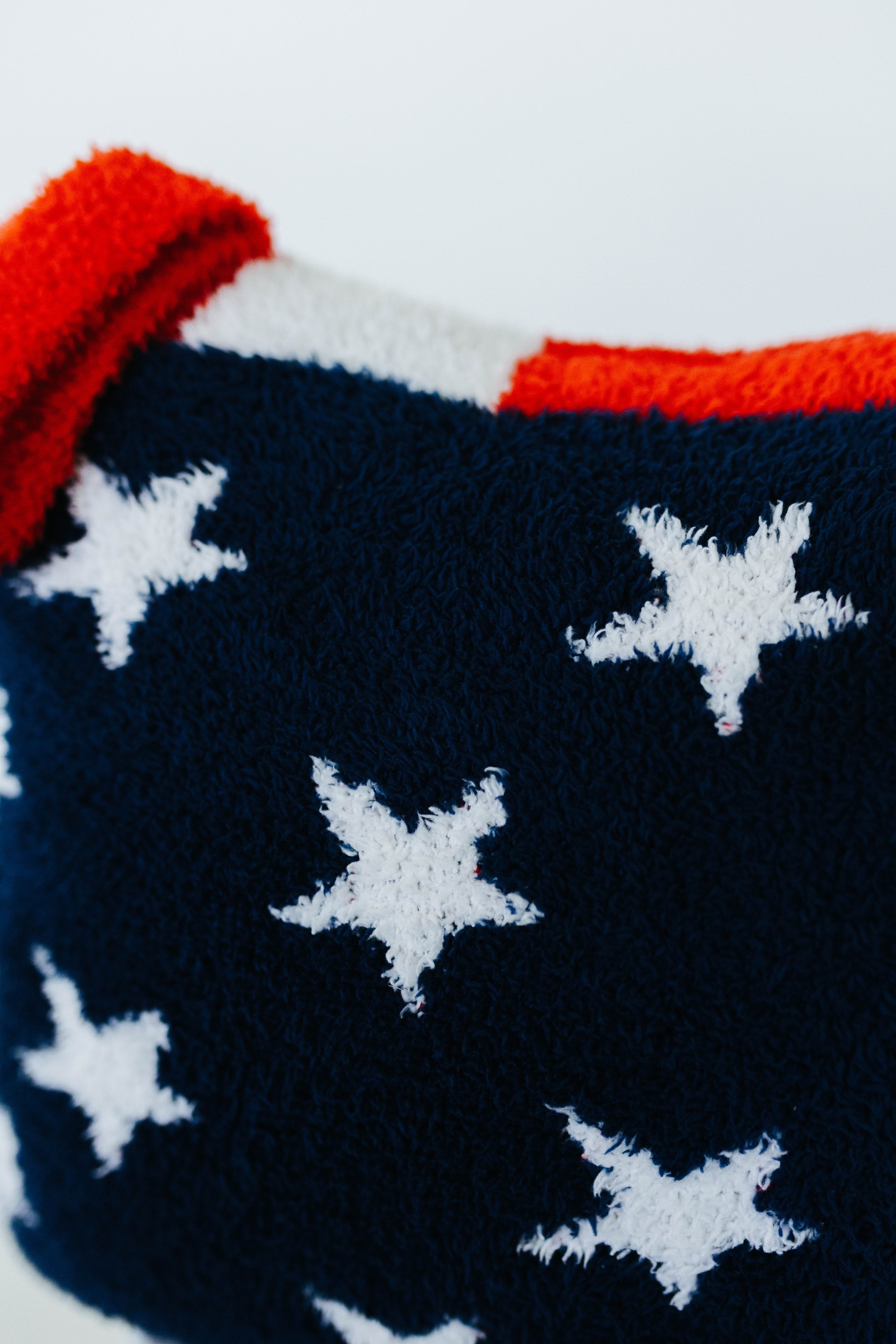 Navy blue fabric with white stars and red and white border
