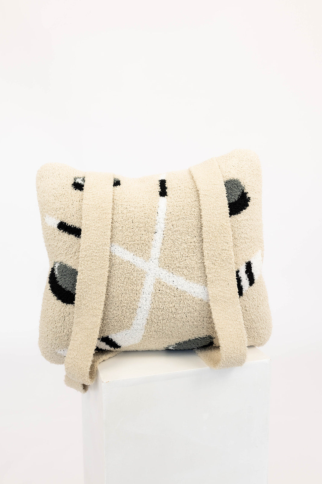 Beige blanket with black and white hockey patterns on a white background