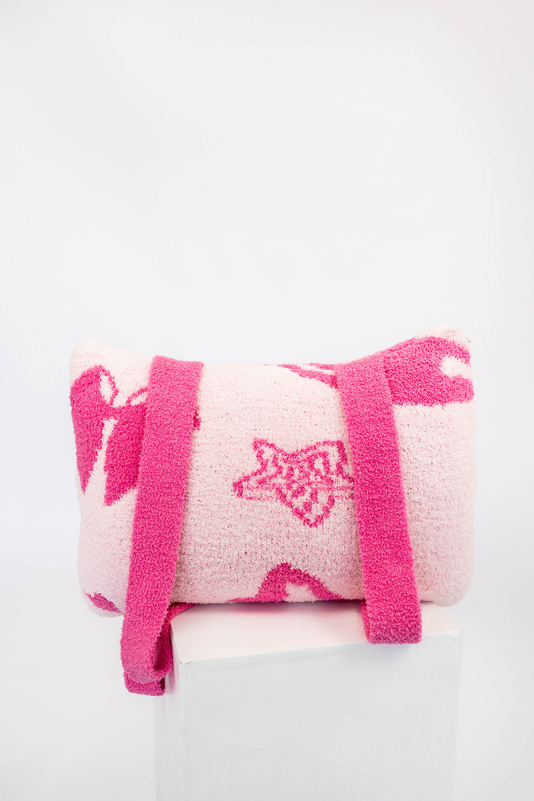 Pink and white cheerleader quillow with straps on a white background