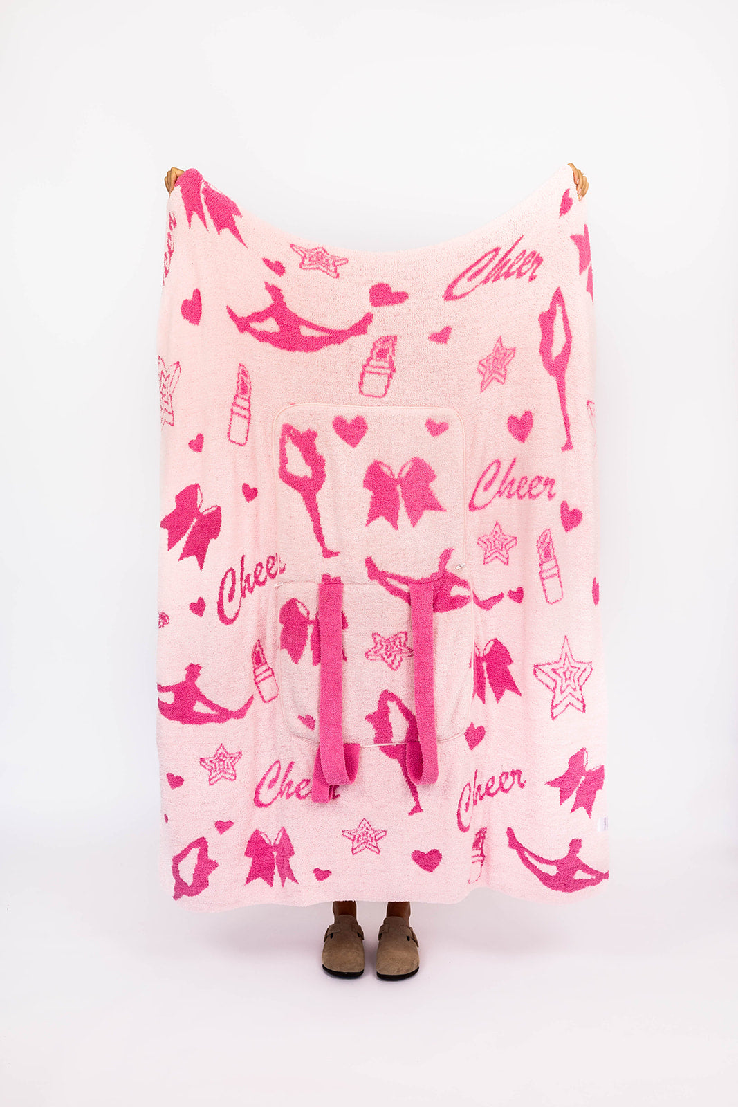 Pink blanket with cheerleading patterns on a white background