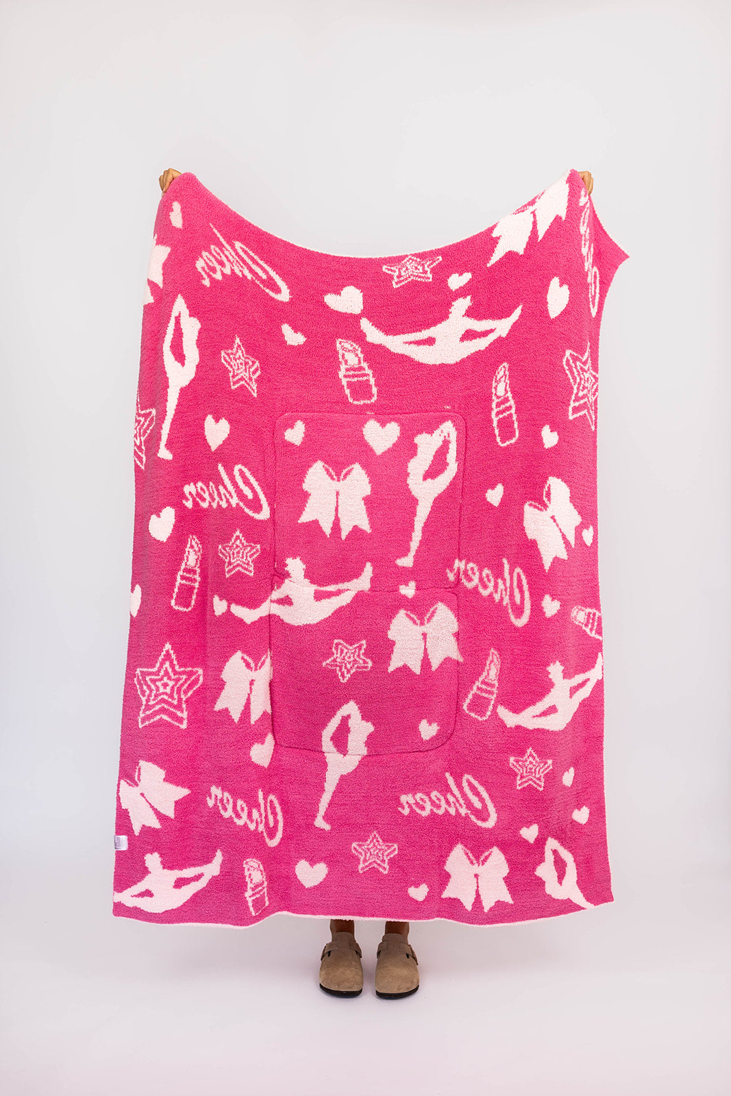 Pink blanket with white cheer graphics on a white background