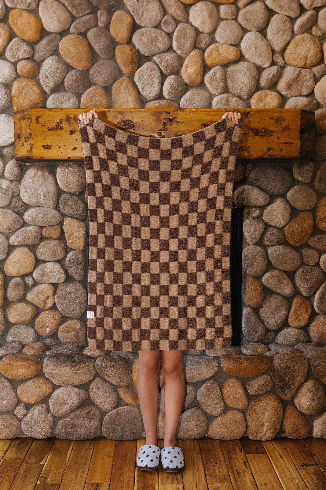 Brown check kids blanket held open to show the checkerboard pattern.
