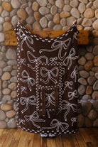 Brown reverse of the blue bow quillow with outlined blue bows.