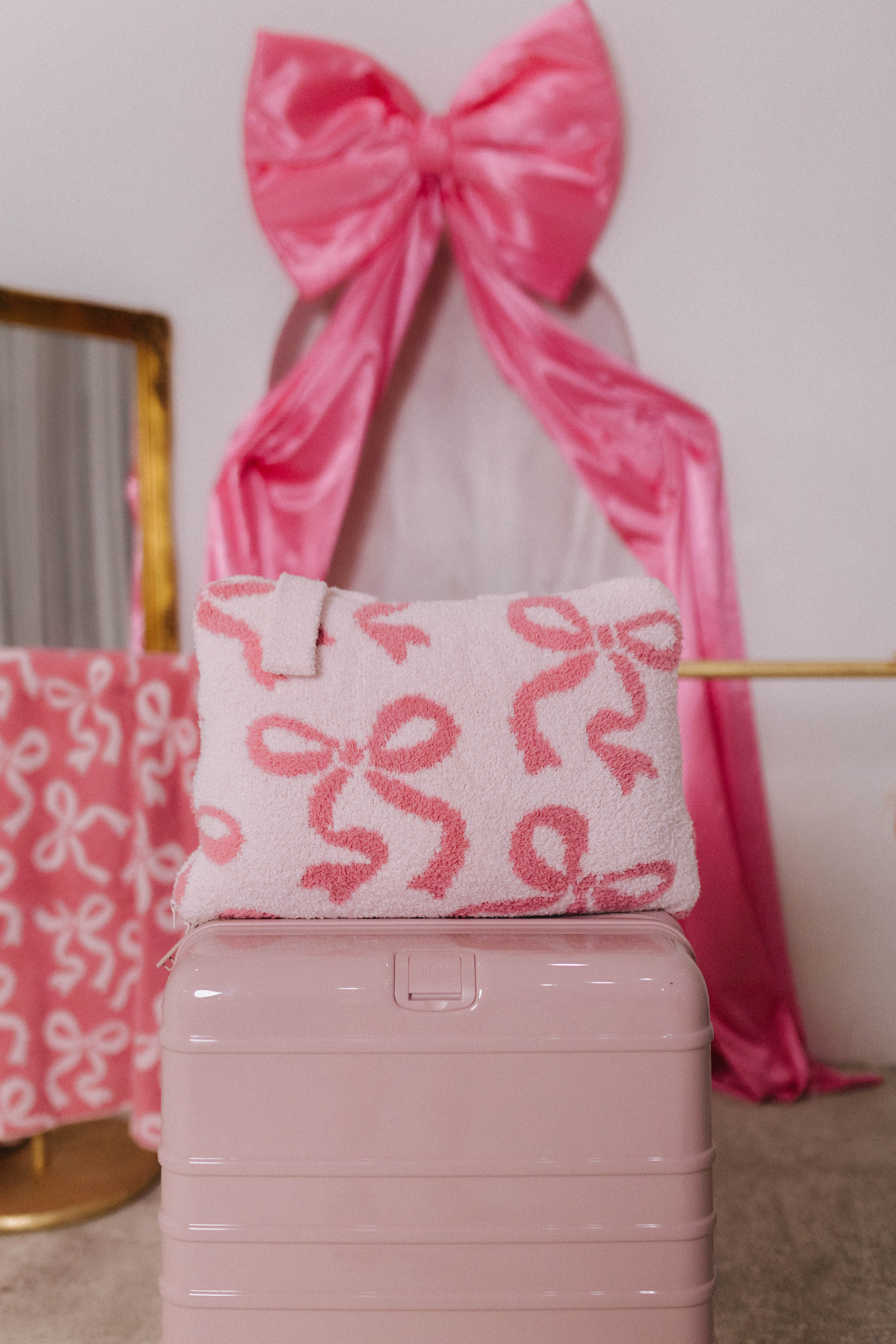 Pink suitcase with a decorative pink bow 