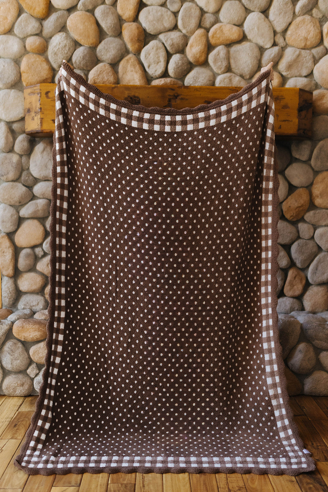 Brown polka dot side of the gingham blanket with a check border.