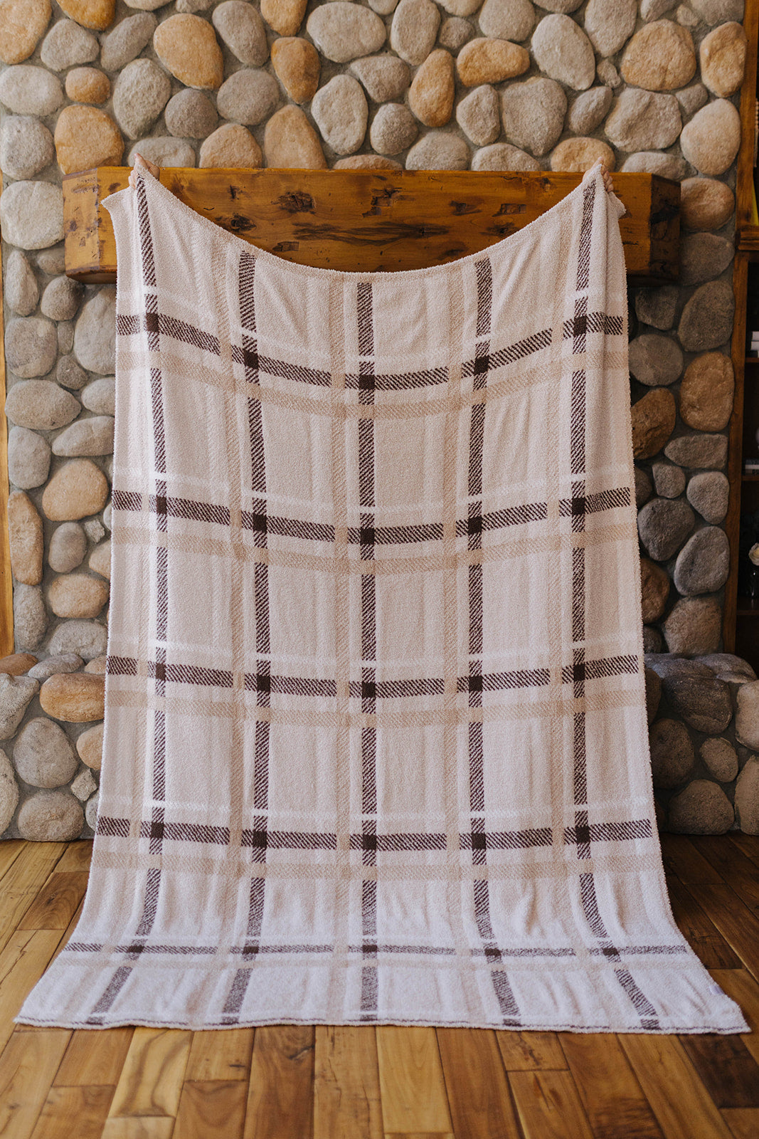 Neutral plaid blanket held open at full size.