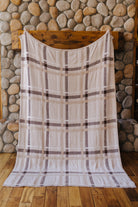 Neutral plaid blanket held open at full size.