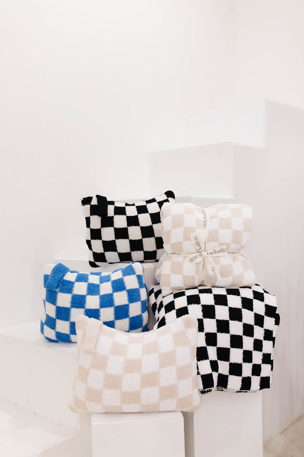 Set of checkered items on a white surface with a white background