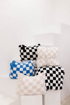 Set of checkered items on a white surface with a white background