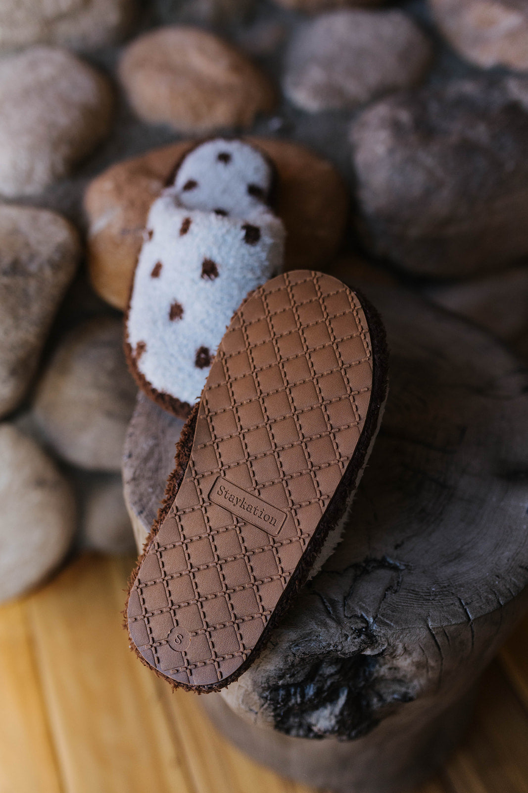 Polka dot slipper turned over to show the brown sole.