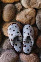 Top view of the blue slippers with brown polka dots.