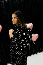 Black and white heart polka dot quillow on women's back