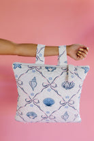 holding the shell print outdoor quillow by the backback straps
