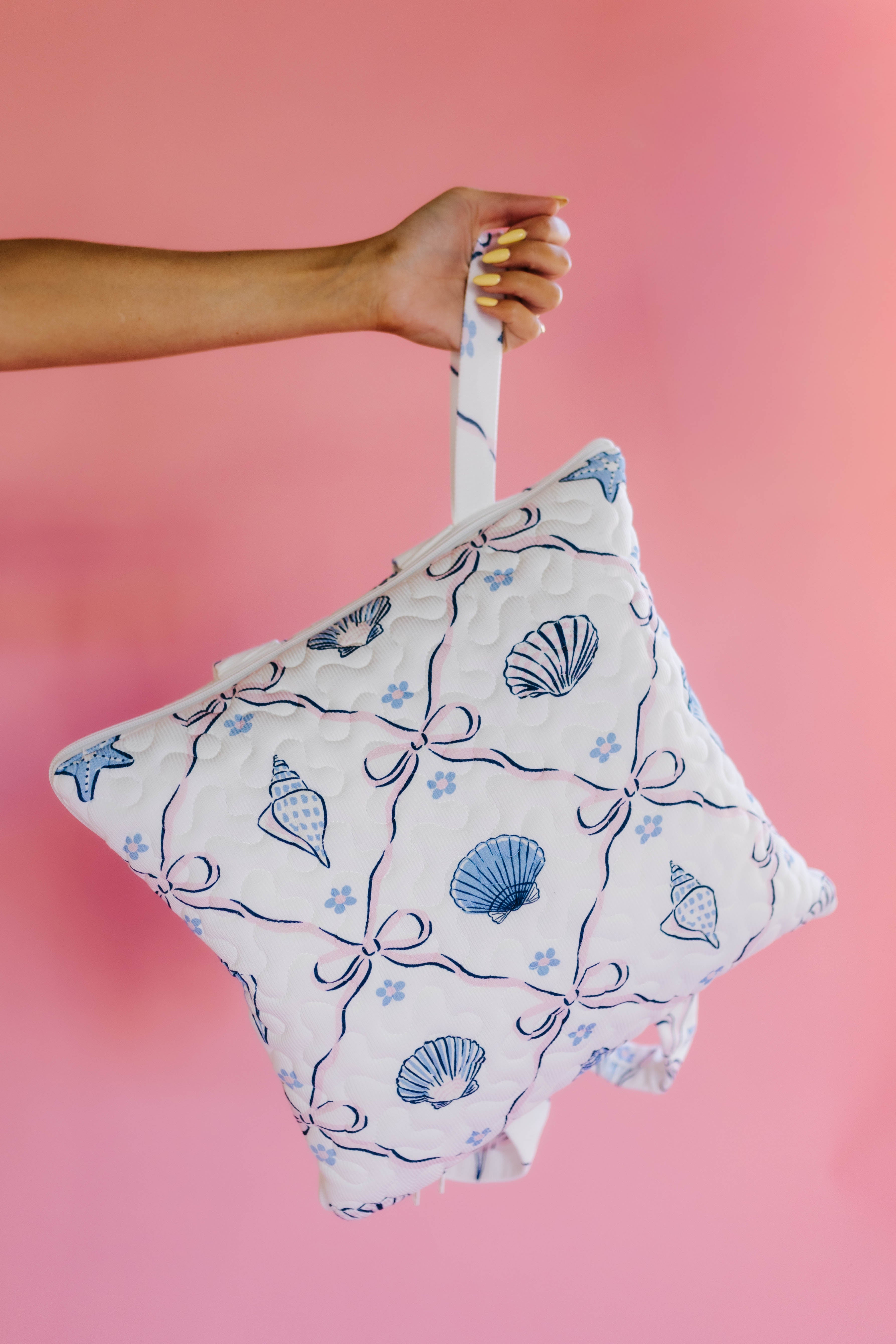 holding the outdoor quillow by the wristlet handle