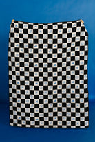 Black and white checkered picnic blanket with blue sea-themed pattern on a blue background