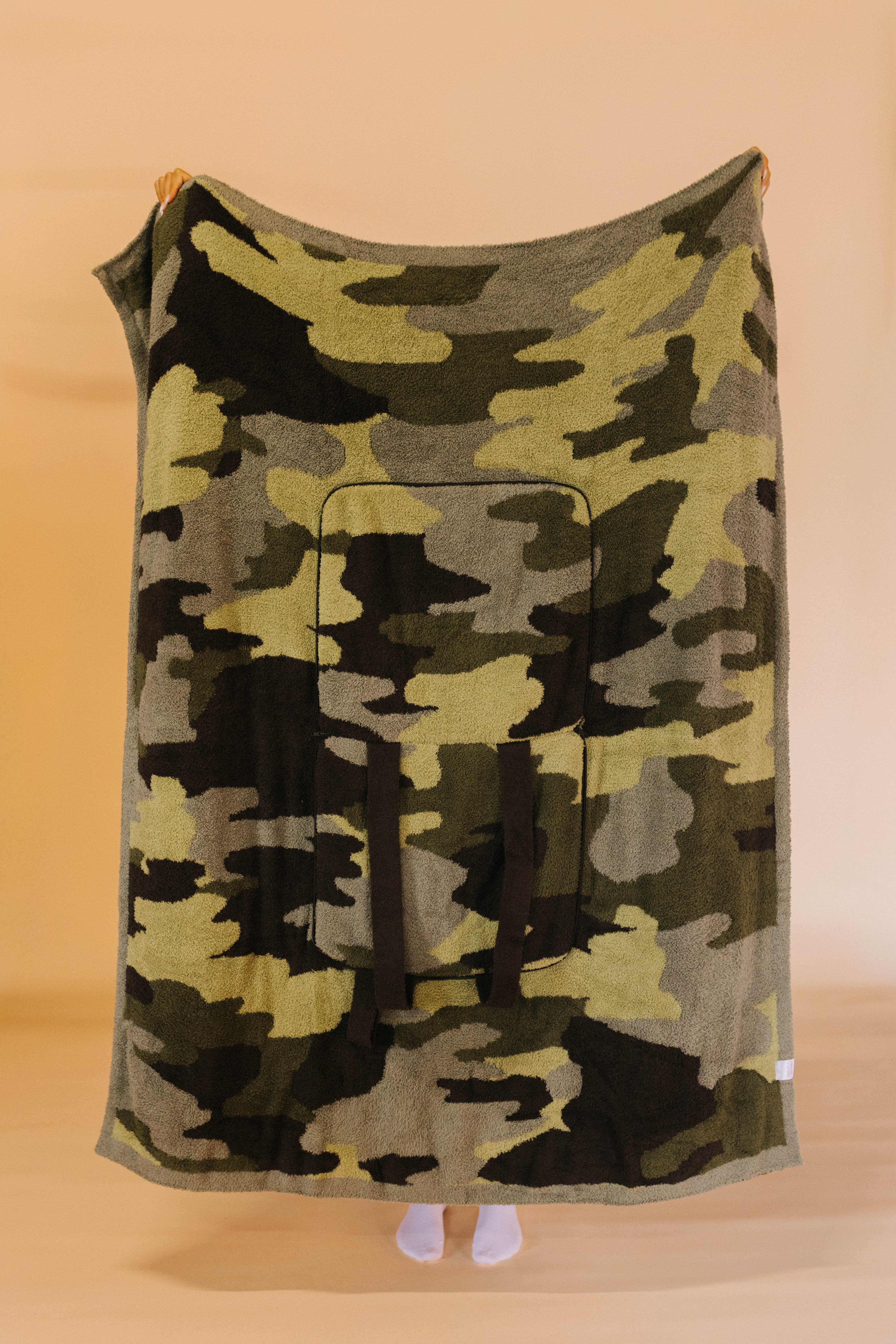 full side of camo quillow while it's being held up