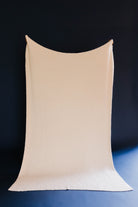 cream ribbed blanket on dark blue background