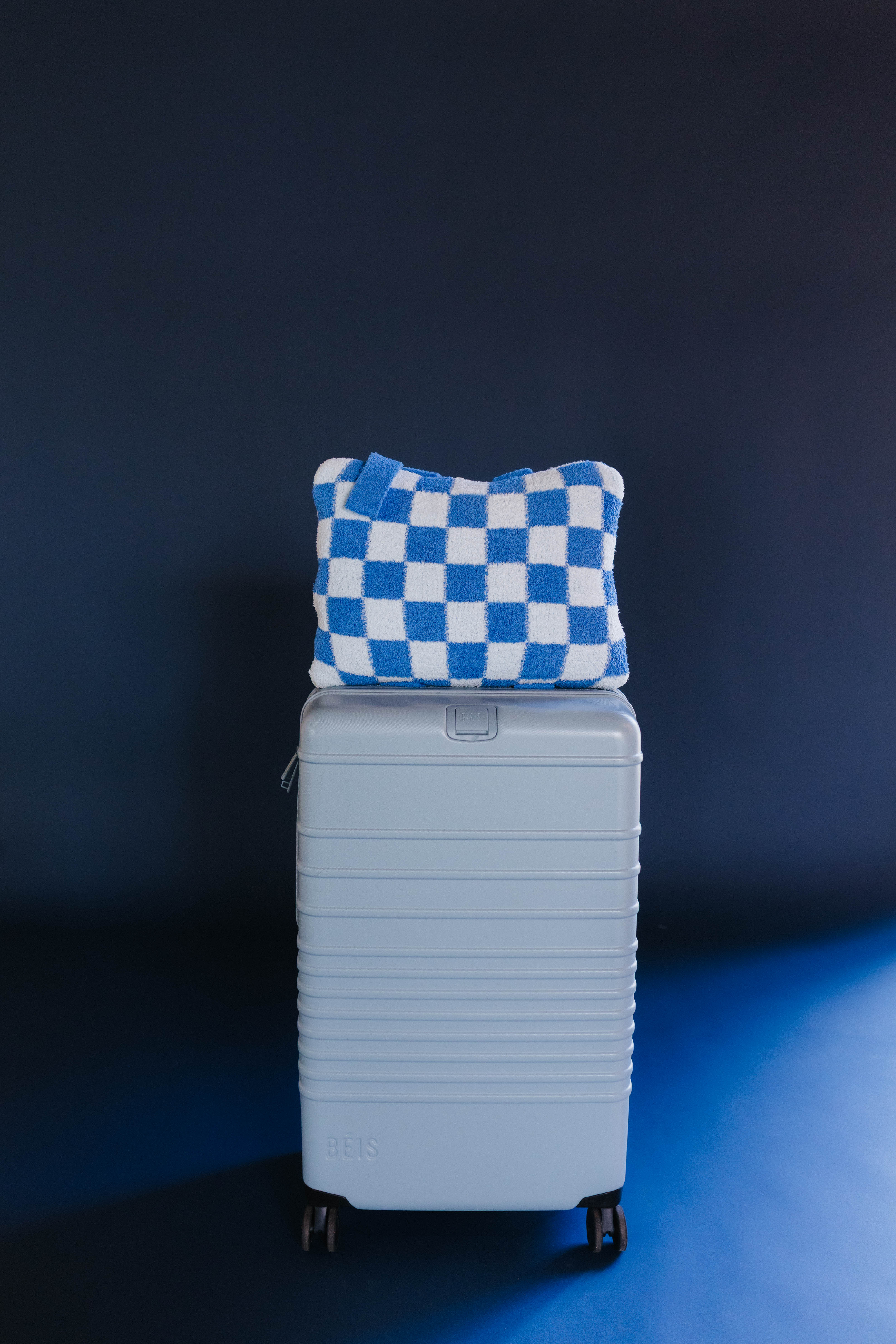 Blue check quillow on light blue suitcase