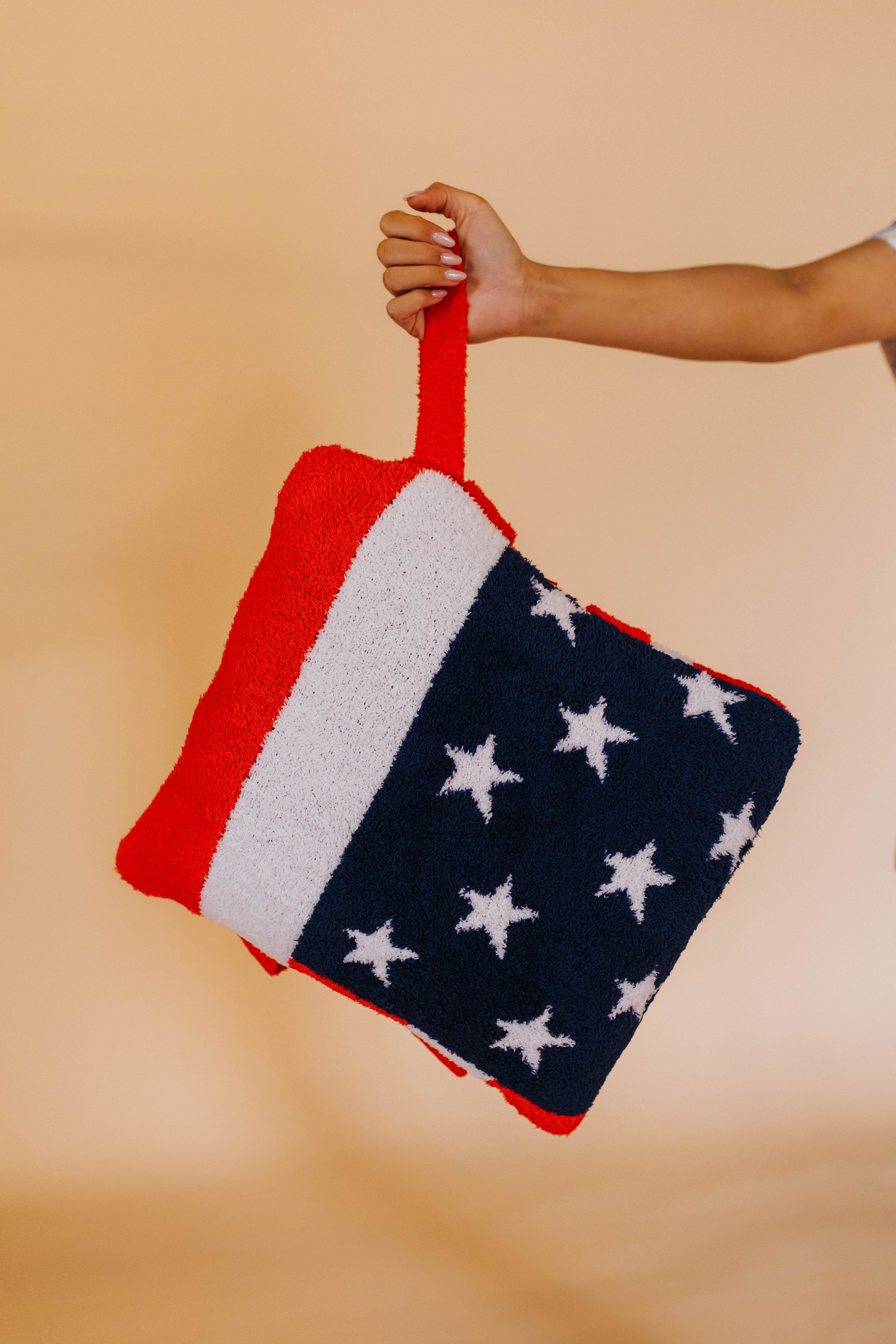 holding the wristlet of the american flag quillow
