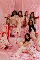 All of the girls modeling the cherry pjs sitting on the kiss pjs
