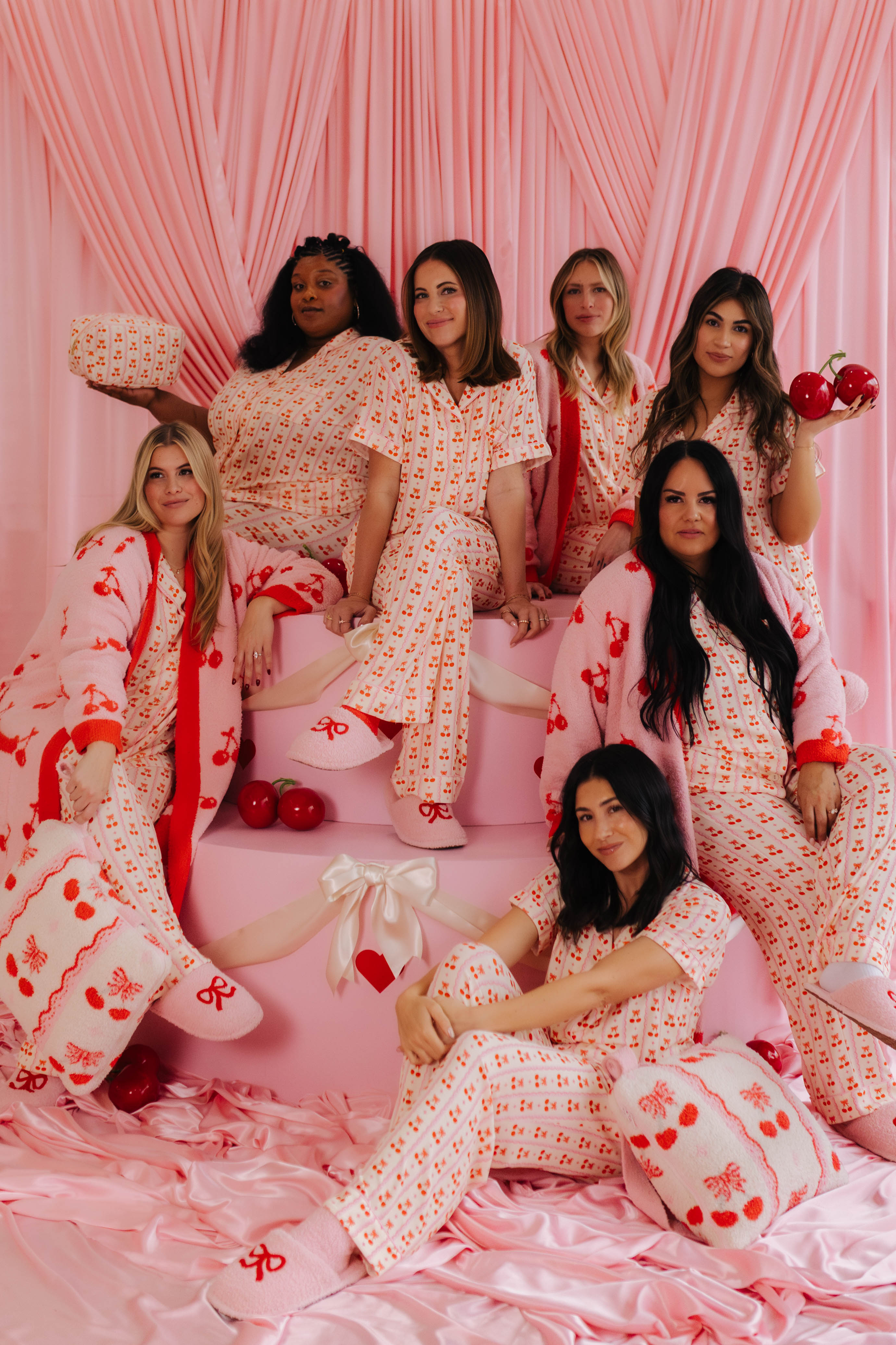 All of the girls modeling the cherry pjs sitting on the kiss pjs