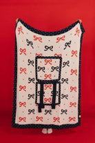 Blanket with bow pattern on a red background
