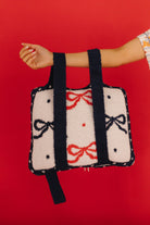 showing hand holding the backpack side of the quillow 