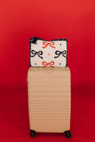 quillow cover with bows and polka dots on beis suitcase