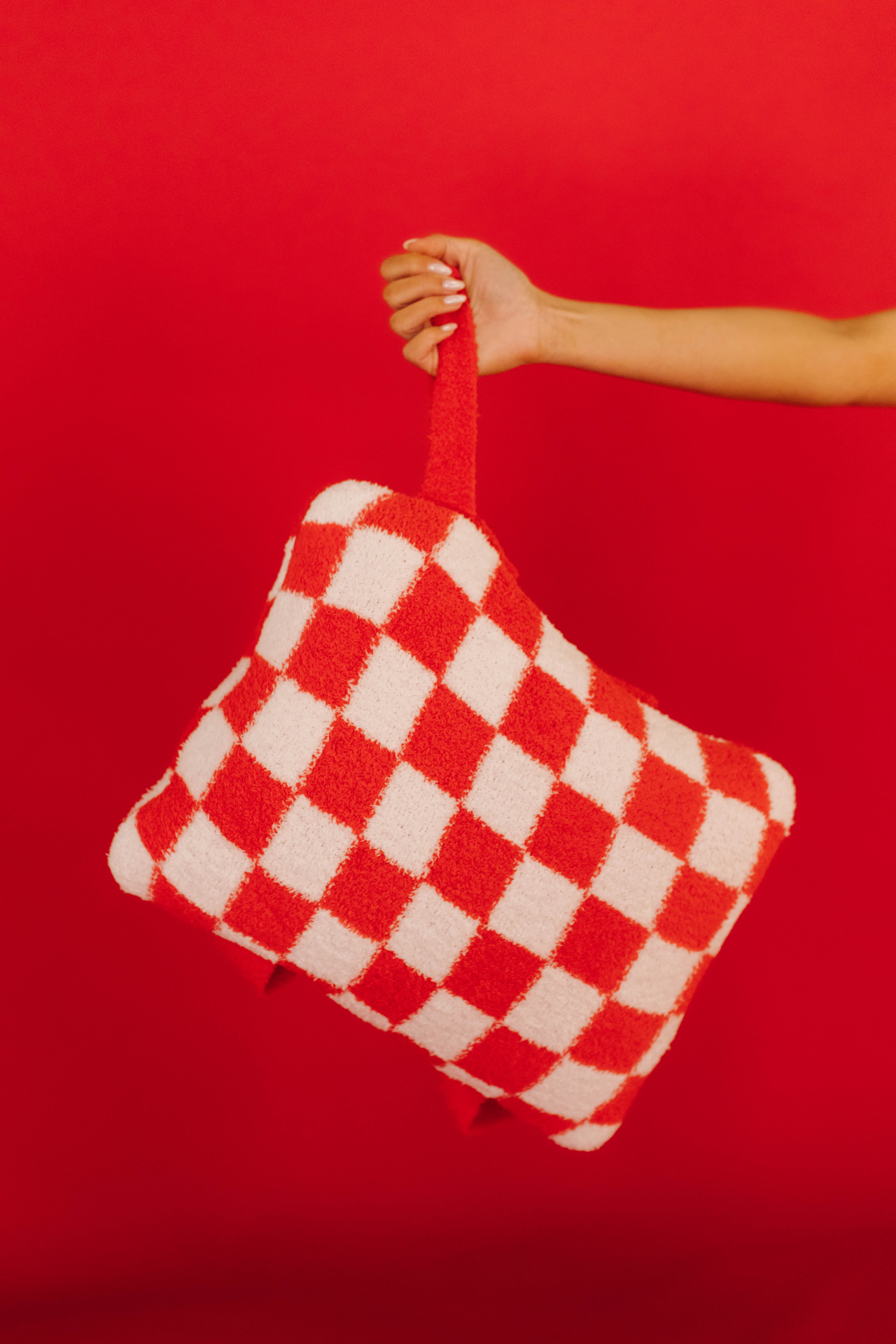 red check quillow being held up by wristlet