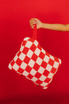 red check quillow being held up by wristlet