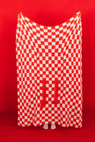 red check quillow being fully held up in front of red background