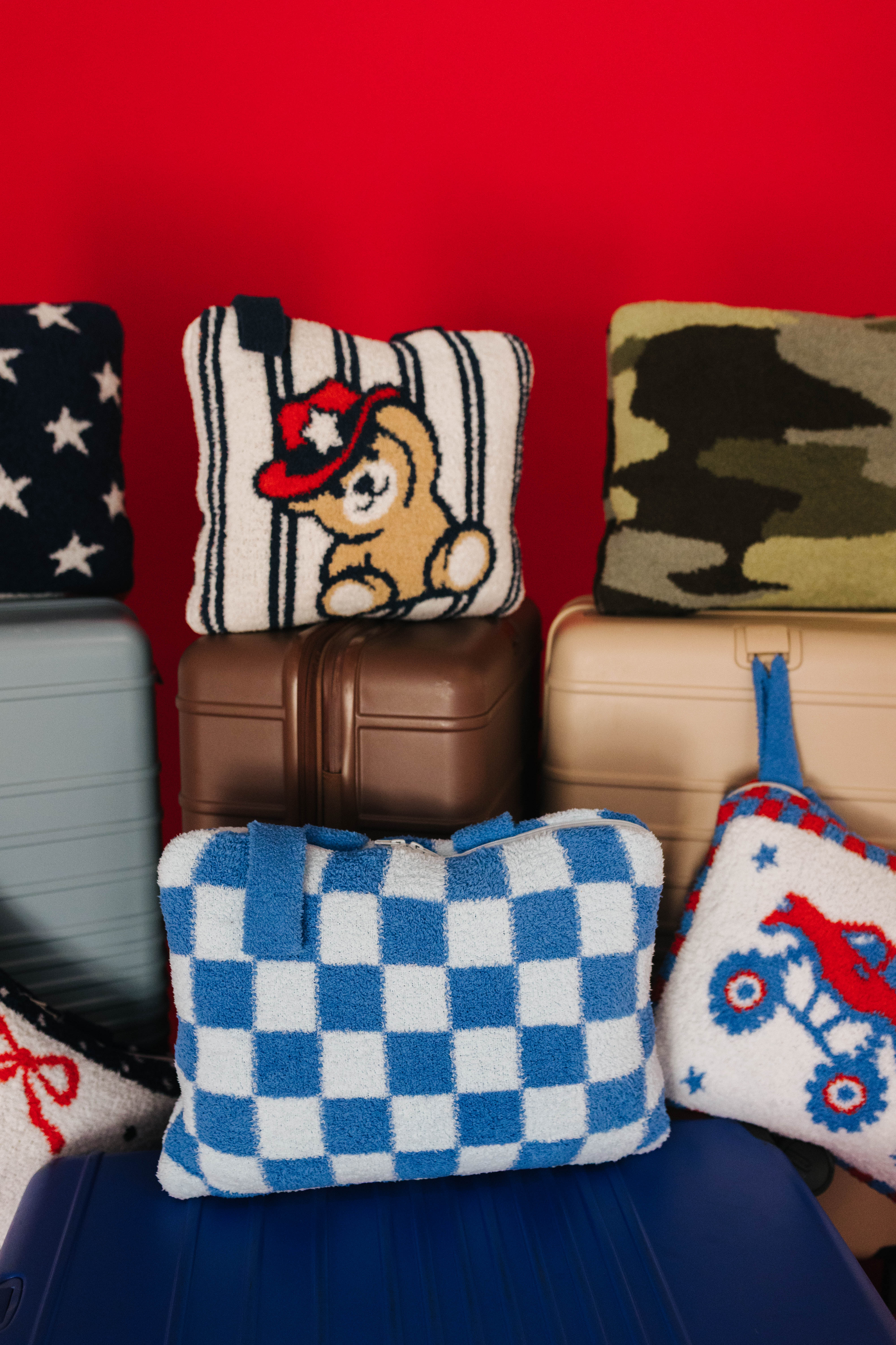 close up of multiple quillow styles on suitcases
