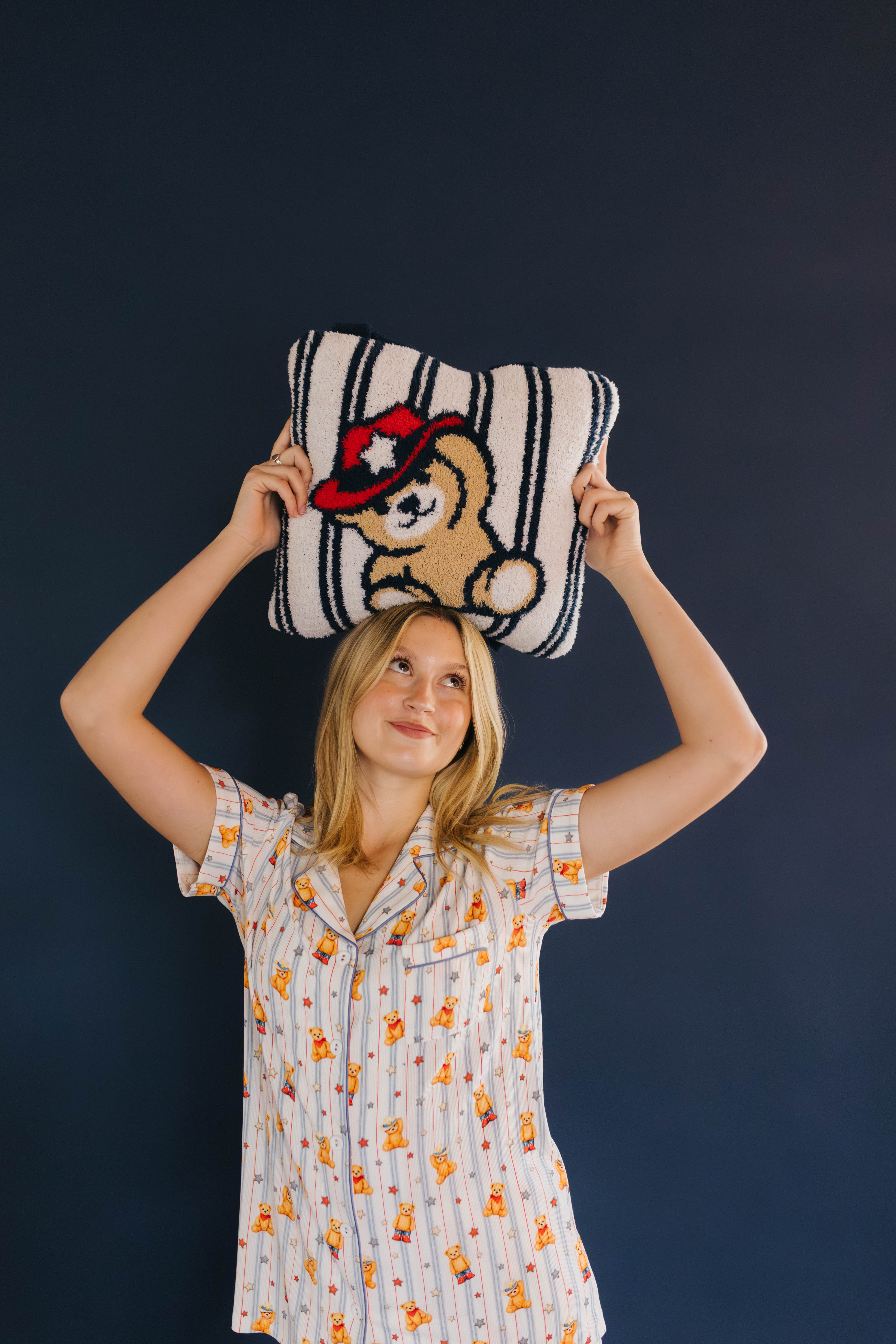 girl holding the quillow on her head 