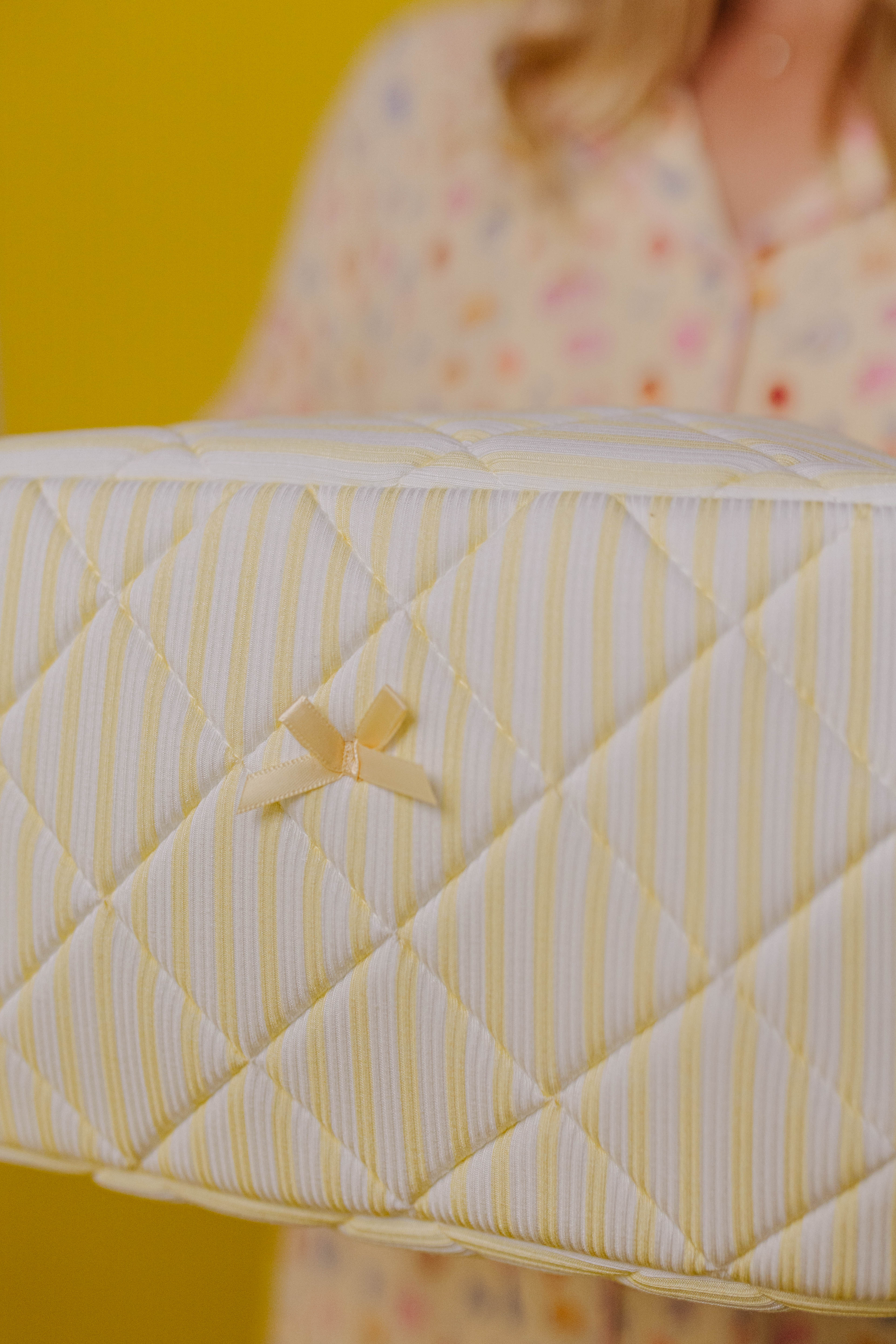 showing the bow detailing and stripe detailing on the bag