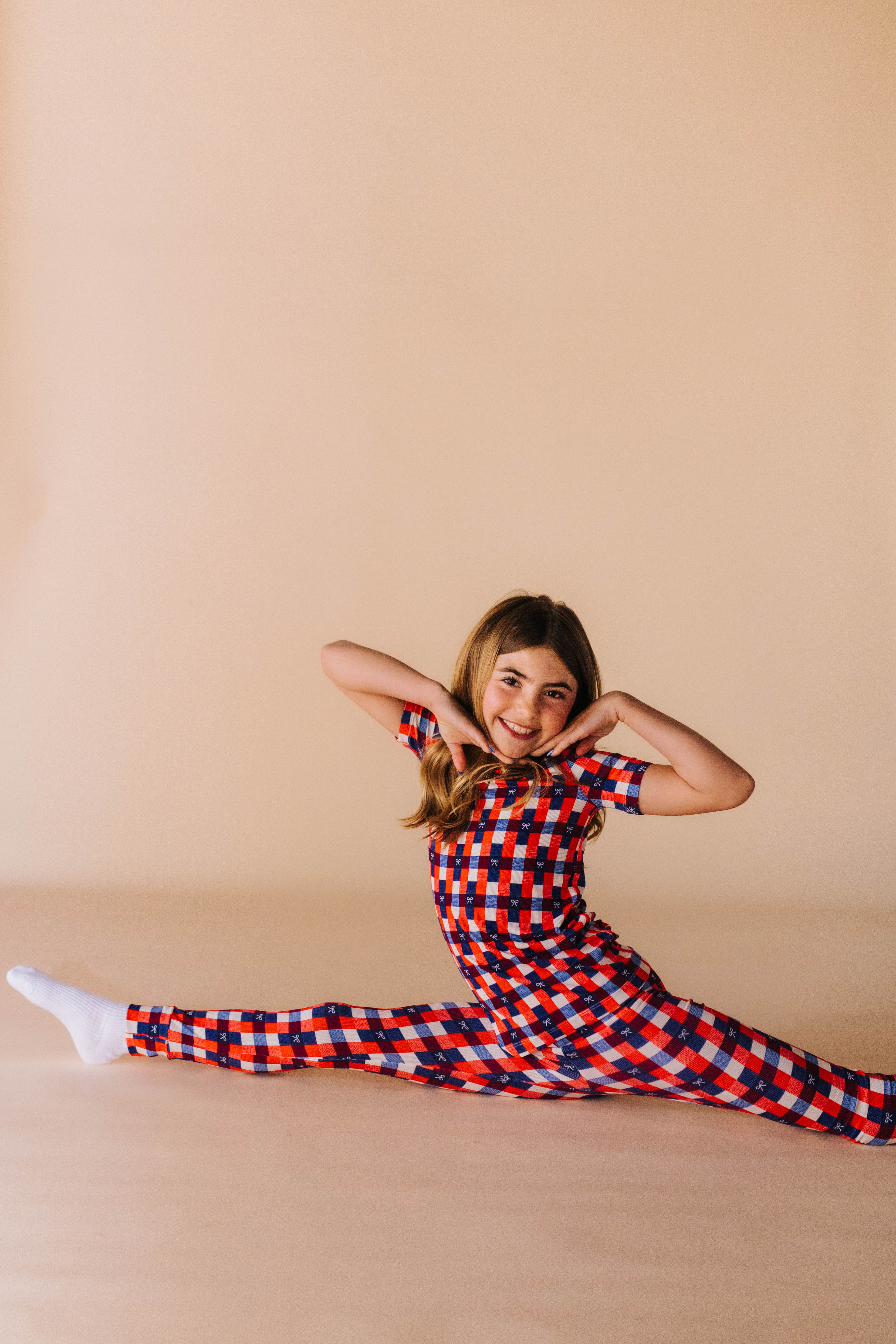 kolly doing the splits in her two piece gingham pj set 