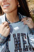 Close view of the Hot Mess sweatshirt neckline with plaid trim.